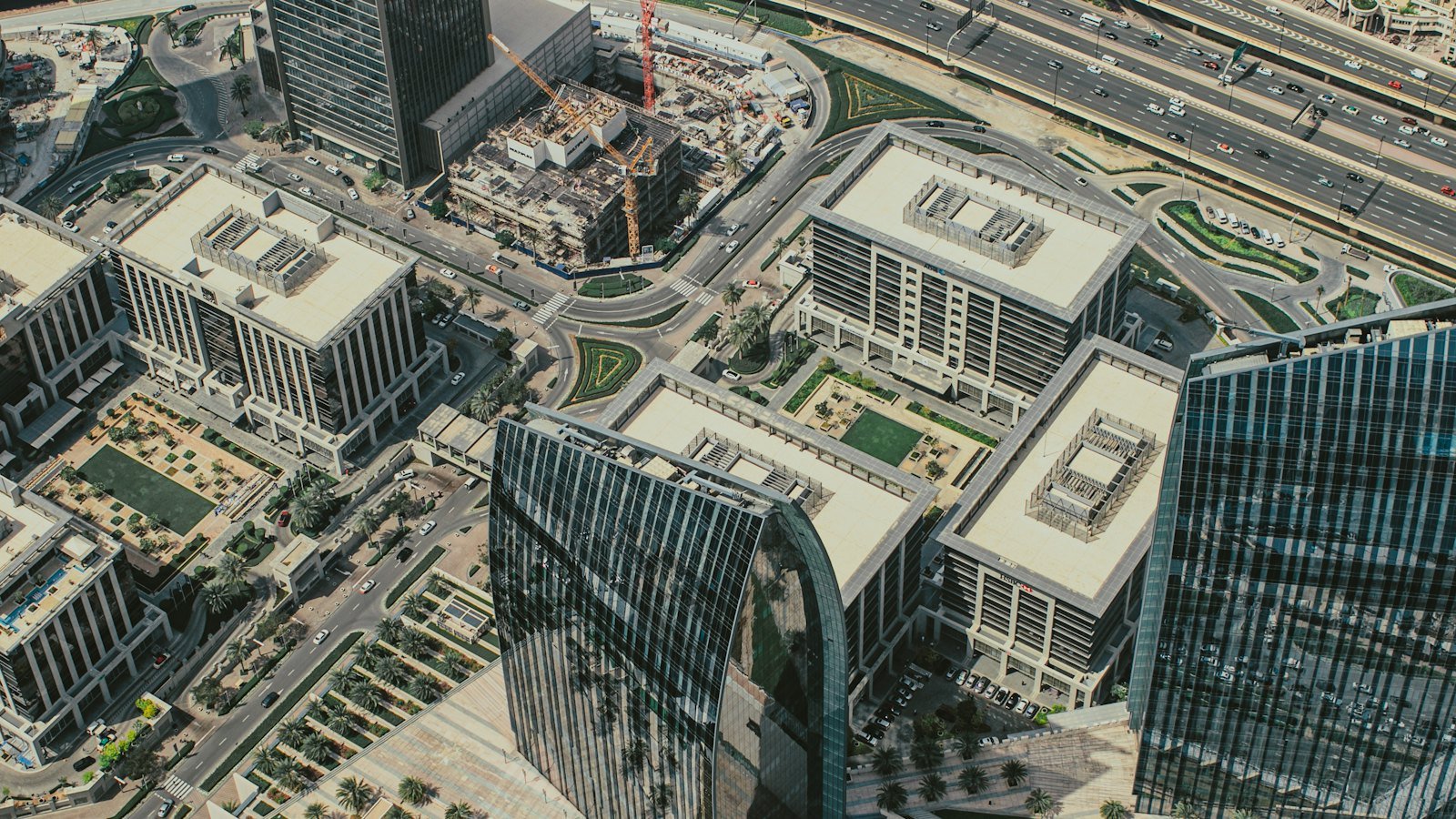 Aerial view of the Dubai skyline with high-rise towers in a modern business district